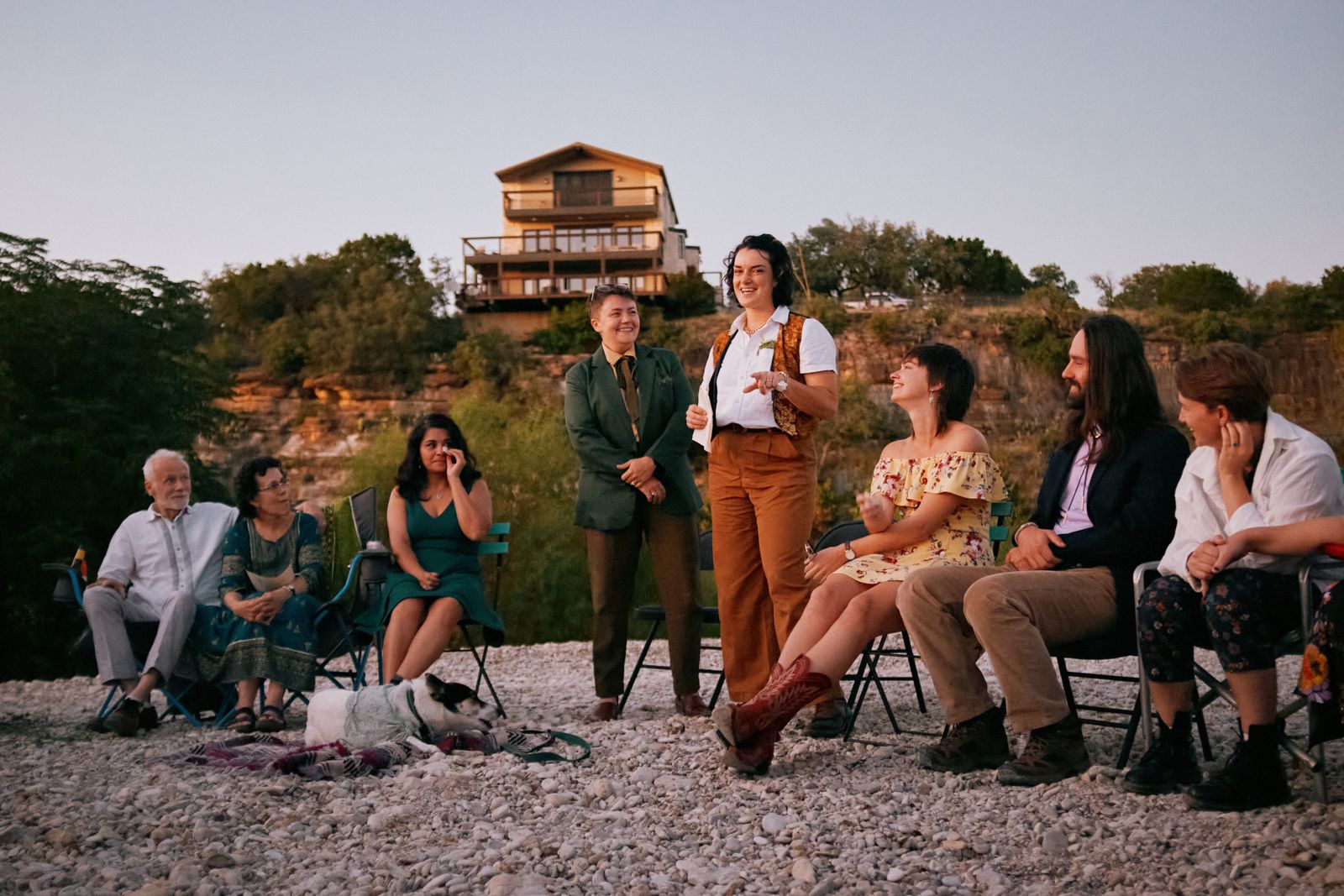 The couple with their guests seated in a circle at an outdoor Quaker-style ceremony